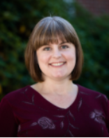 Headshot of Elizabeth Watts Pope, depicting a smiling woman with short brown hair with bangs, wearing a maroon sweater.